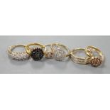 Four assorted modern 9ct gold and white or coloured diamond cluster set dress rings and two