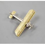 An early 20th century 15ct, white metal and three stone diamond set bi-plane brooch, with