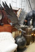 A large cast metal faux bronze eagle, salmon and orb garden ornament, height 200cm