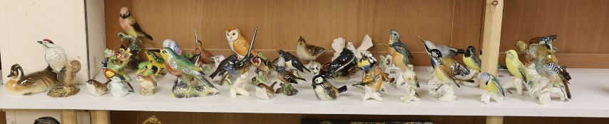 A large collection of ceramic bird figures including Beswick, Russian models, Karl Ens etc