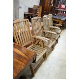 A set of four weathered teak folding garden armchairs, width 63cm, depth 56cm, height 114cm