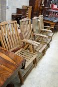 A set of four weathered teak folding garden armchairs, width 63cm, depth 56cm, height 114cm