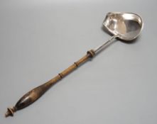 A Swedish? white metal punch ladle, with turned wooden handle, 42.5cm.