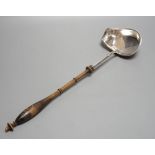 A Swedish? white metal punch ladle, with turned wooden handle, 42.5cm.