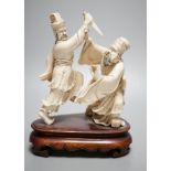 An early 20th century Chinese ivory group of two fighting officials - 21cm tall