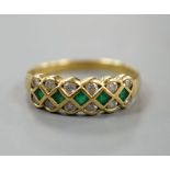 A modern 18ct gold, emerald and diamond line cluster set half hoop ring, size R, gross 3.9 grams.