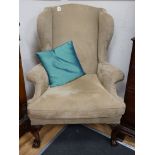 A heavy large upholstered wing armchair, width 92cm, depth 90cm, height 126cm