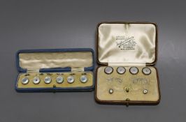 A set of four 18ct, mother of pearl, enamel and seed pearl set buttons, gross 7.2 grams, two similar