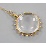 An early 20th century 15ct mounted eye glass pendant, 29mm, on a yellow metal fine link chain, gross