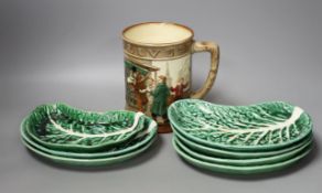 A Doulton Oliver Twist mug and eight Portuguese leaf dishes