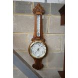 A late Victorian carved oak aneroid barometer and thermometer, height 84cm