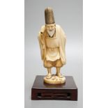 A Japanese ivory figure of a court official, wearing a tall eboshi hat, Taisho period, signed to a