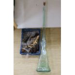 A novelty pressed bottle-green glass rifle and a collection of novelty glass pistols and cannon,