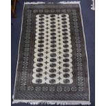 A Bokhara ivory ground rug, 246 x 156cm