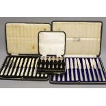 Two cased sets of silver or mother of pearl handled tea knives and a cased set of six silver