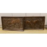 A pair of 1930's carved oak panels of deer grazing, 84 cms wide x 52 cms high.