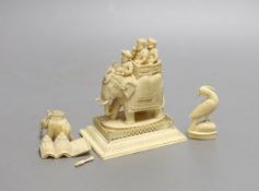 A 19th century Indian carved ivory of figures on a caparisoned elephant, 8.5cm tall, and two other