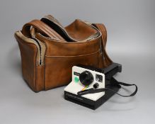 A Polaroid 'card' camera in brown leather case