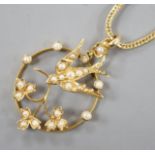 An Edwardian 15ct and seed pearl set openwork 'swallow and flower' pendant, 26mm, gross 2.5 grams,