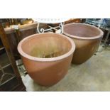 A pair of large circular terracotta planters, diameter 79cm, height 69cm