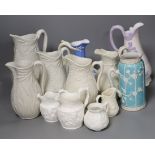 A collection of twelve Victorian relief moulded jugs