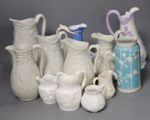 A collection of twelve Victorian relief moulded jugs