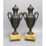A pair of bronzed spelter urns on marbled base - 40cm tall