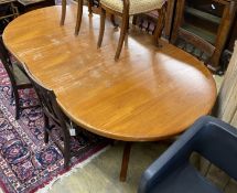 A mid century Danish teak circular extending dining table, two spare leaves, 220cm extended, width