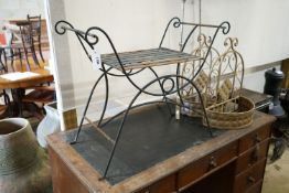 A wrought iron X framed stool, a pair of hanging planters and two large candle holders