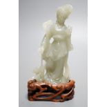 A Chinese celadon jade figure of a lady wood stand,13 cms high.