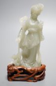 A Chinese celadon jade figure of a lady wood stand,13 cms high.