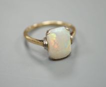A 9ct and 'emerald' cut white opal set ring, size R, gross weight 3.2 grams.