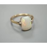 A 9ct and 'emerald' cut white opal set ring, size R, gross weight 3.2 grams.