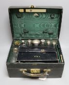 An early 20th century travelling toilet case by Cornhill, London, with seven harlequin silver