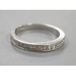 A platinum and twelve stone diamond set half eternity ring, size R, gross weight 6.4 grams.