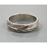 A modern bright cut engraved platinum wedding band, size K,4 grams.