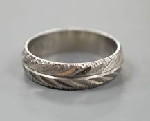 A modern bright cut engraved platinum wedding band, size K,4 grams.