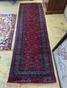 A Bokhara burgundy ground runner, 276 x 88cm