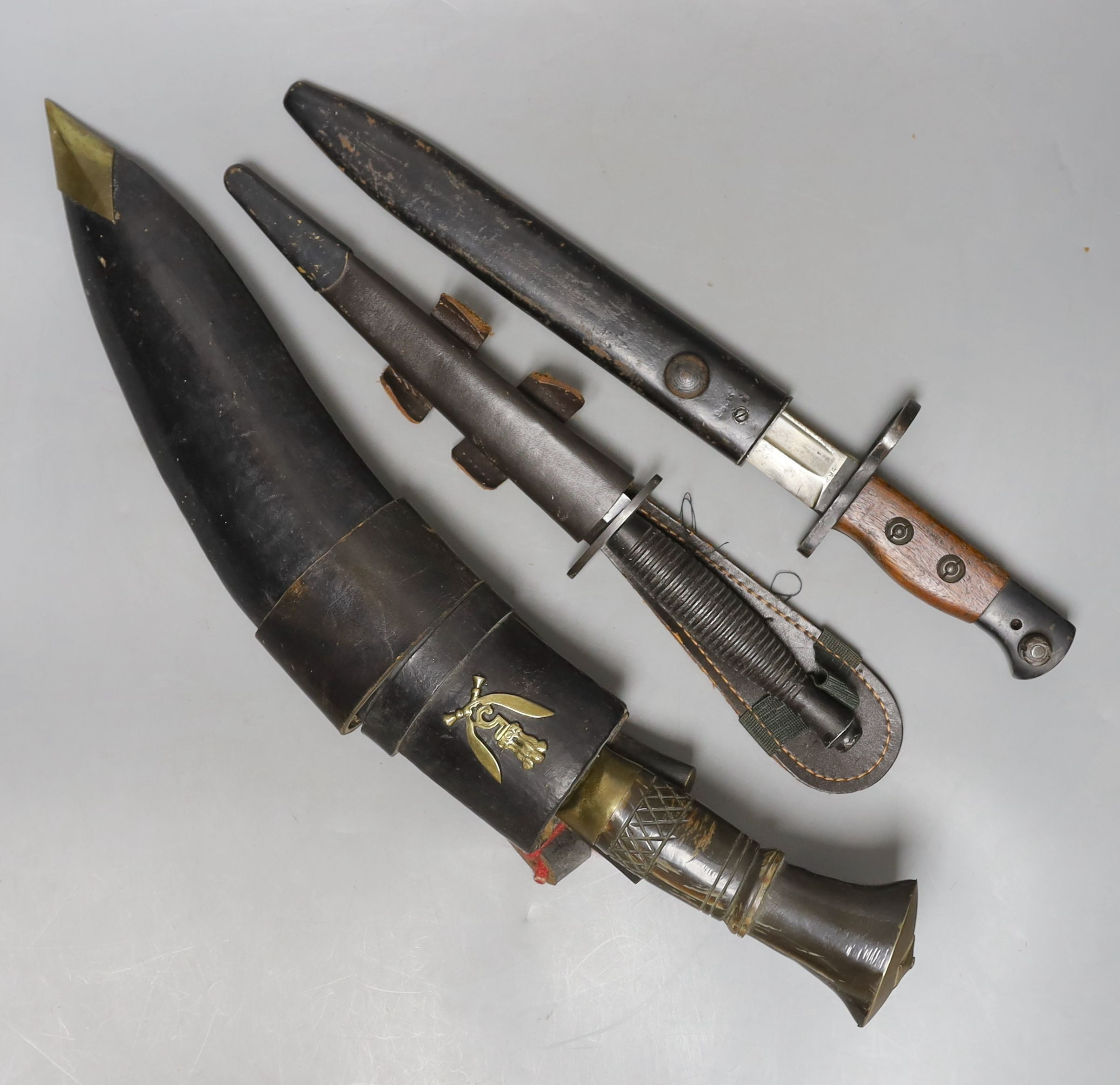 A kukri, small bayonet and a dagger, all with scabbards