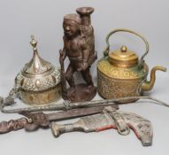 A group of Middle Eastern metalware, a kris, a jambiya, and a figurative carving, 31 cms high.