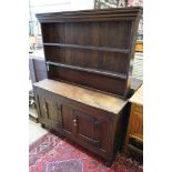 A 18th century and later small oak dresser with boarded rack, width 127cm depth 38cm height 166cm