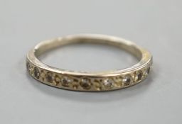 A white metal and diamond chip set half eternity ring, size K,gross 1.9 grams.