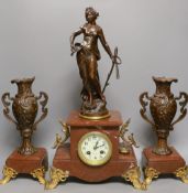 A French figurative early 20th century rouge marble clock garniture,Clock 51 cms high.