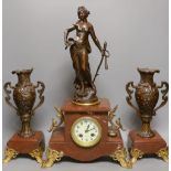 A French figurative early 20th century rouge marble clock garniture,Clock 51 cms high.