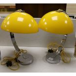 A pair of contemporary chrome reading lamps with yellow glass domed shades,46 cms high.