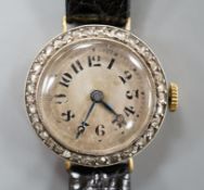 A lady's early 20th century 18k and diamond set manual wind wrist watch, on later leather strap,