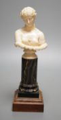 A 19th-century Dieppe ivory bust of Clytie, on a marble and rosewood pedestal, after the model in