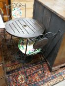 A circular cast iron based garden table, diameter 60cm together with two wrought iron mosaic folding