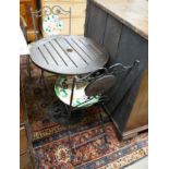 A circular cast iron based garden table, diameter 60cm together with two wrought iron mosaic folding