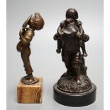An early 20th century bronze of a boy licking a plate and a Victorian bronze group - tallest 15cm